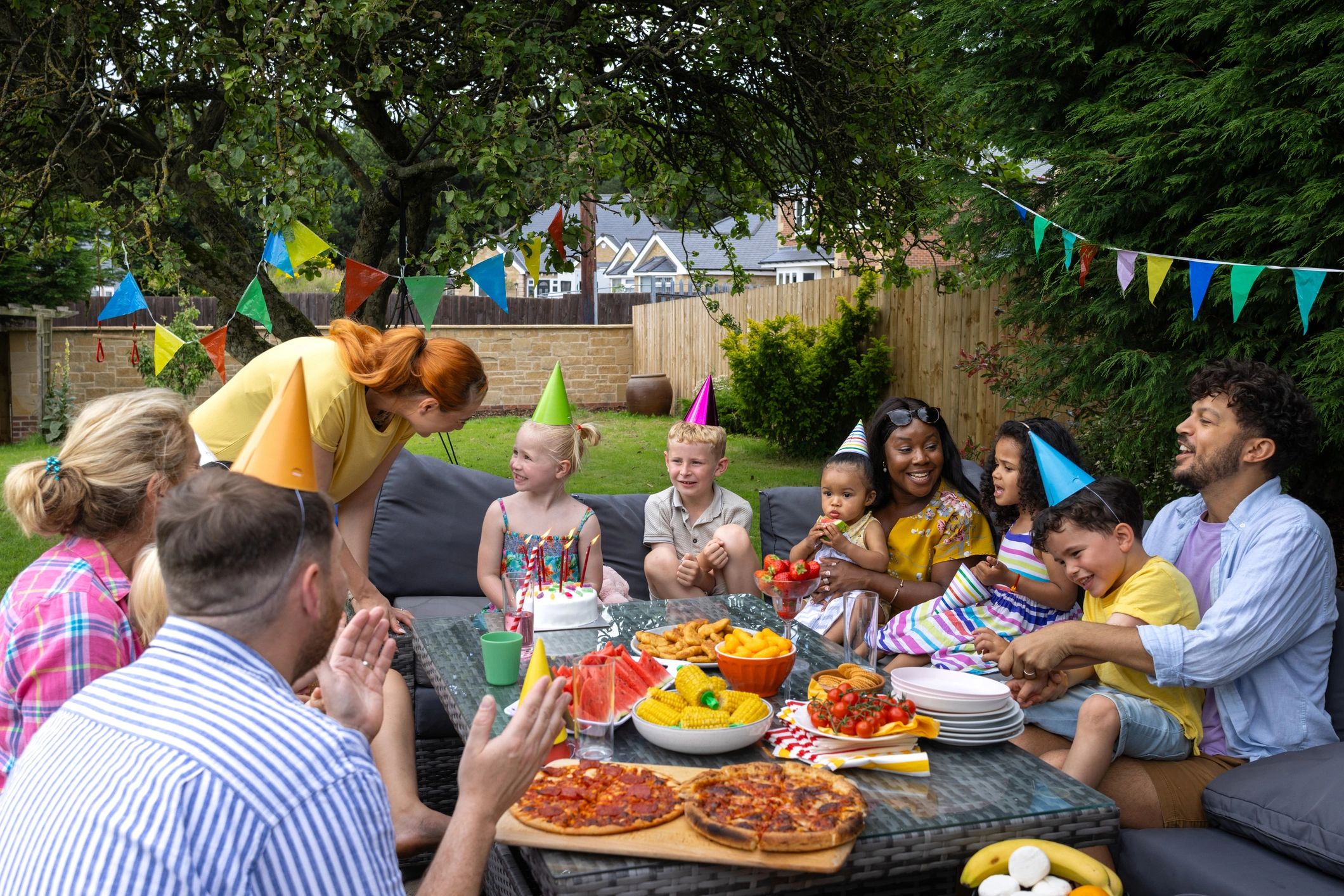 Outdoor celebration with families gathered around a table