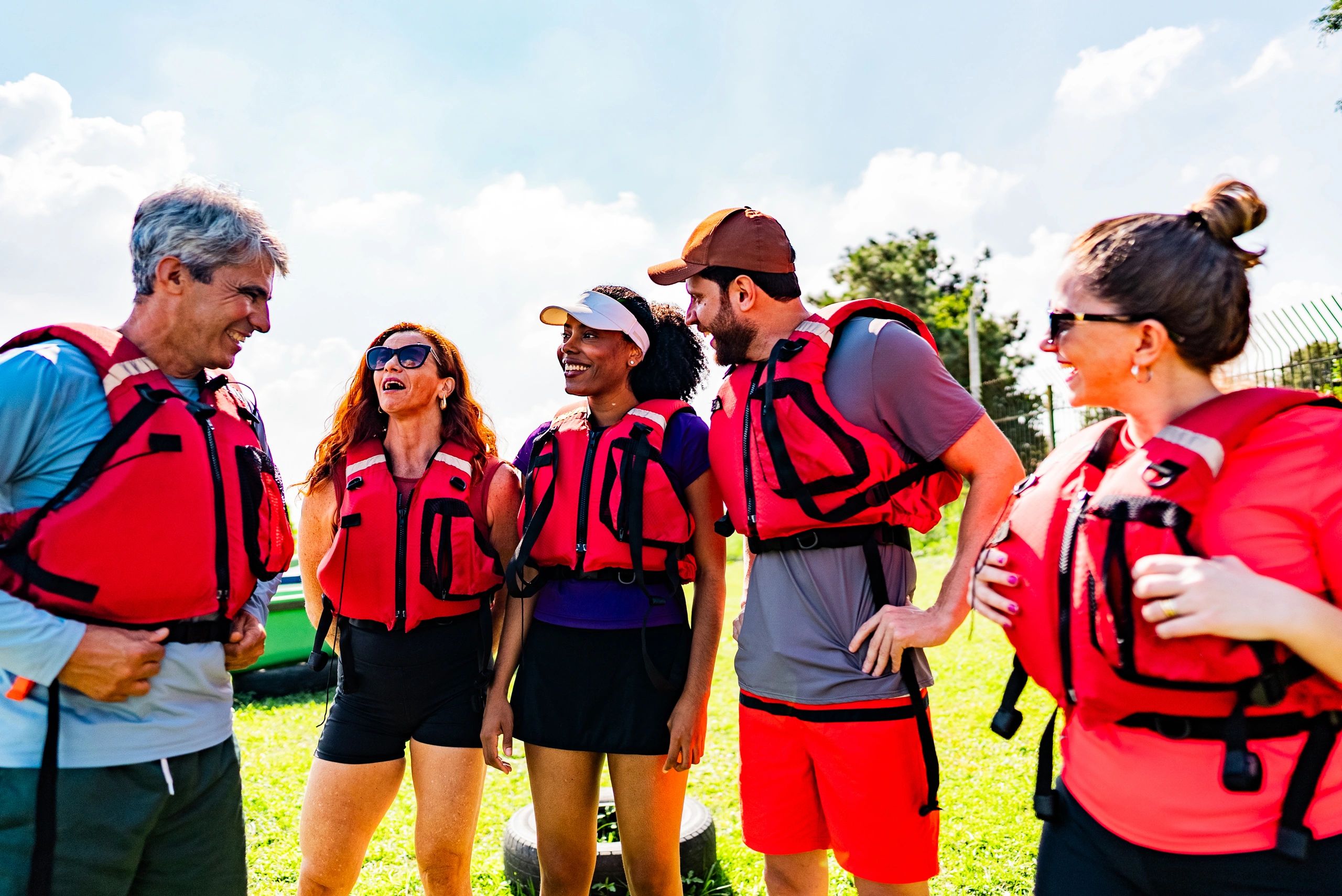 Guests and hosts talking outdoors in a relaxed natural setting