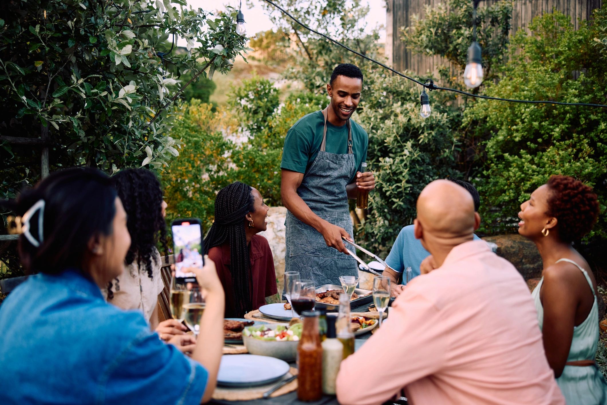 Outdoor shared meal in a garden setting
